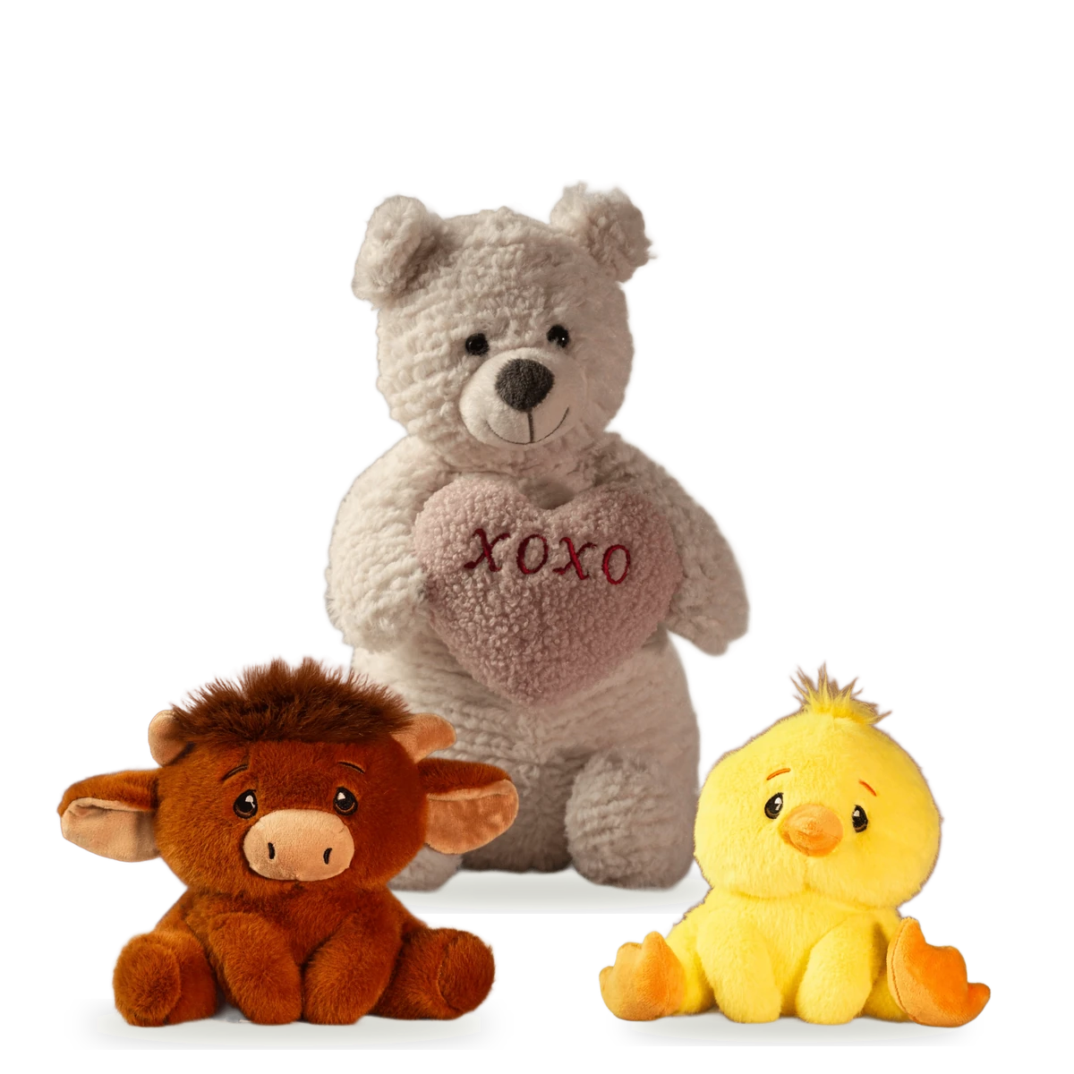 Plush friends: a bear holding an XOXO heart, a highland cow and a yellow chick